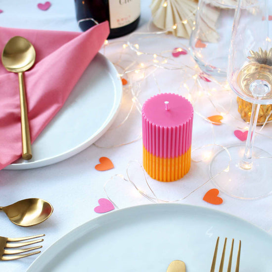 Image of pink and orange candle on a Galentine's Day dinner party tablescape