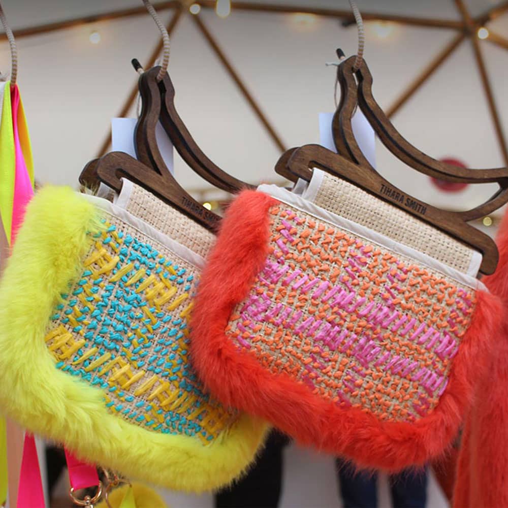 Tihara Smith at Hemingway Design's annual SAMPLE Christmas event at the Greenwich Peninsula. Picture shows Tihara's handcrafted raffia bags in yellow and blue and orange and pink. 