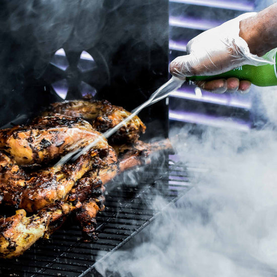 Jerk chicken being cooked on the grill - Caribbean recipes with chicken example