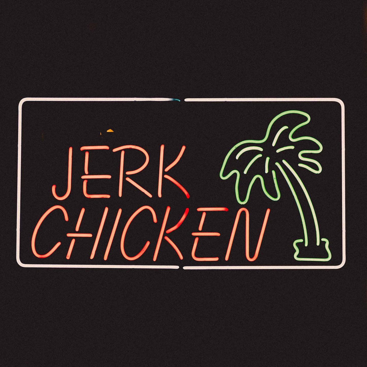 Image of jerk chicken neon sign for Caribbean restaurants London