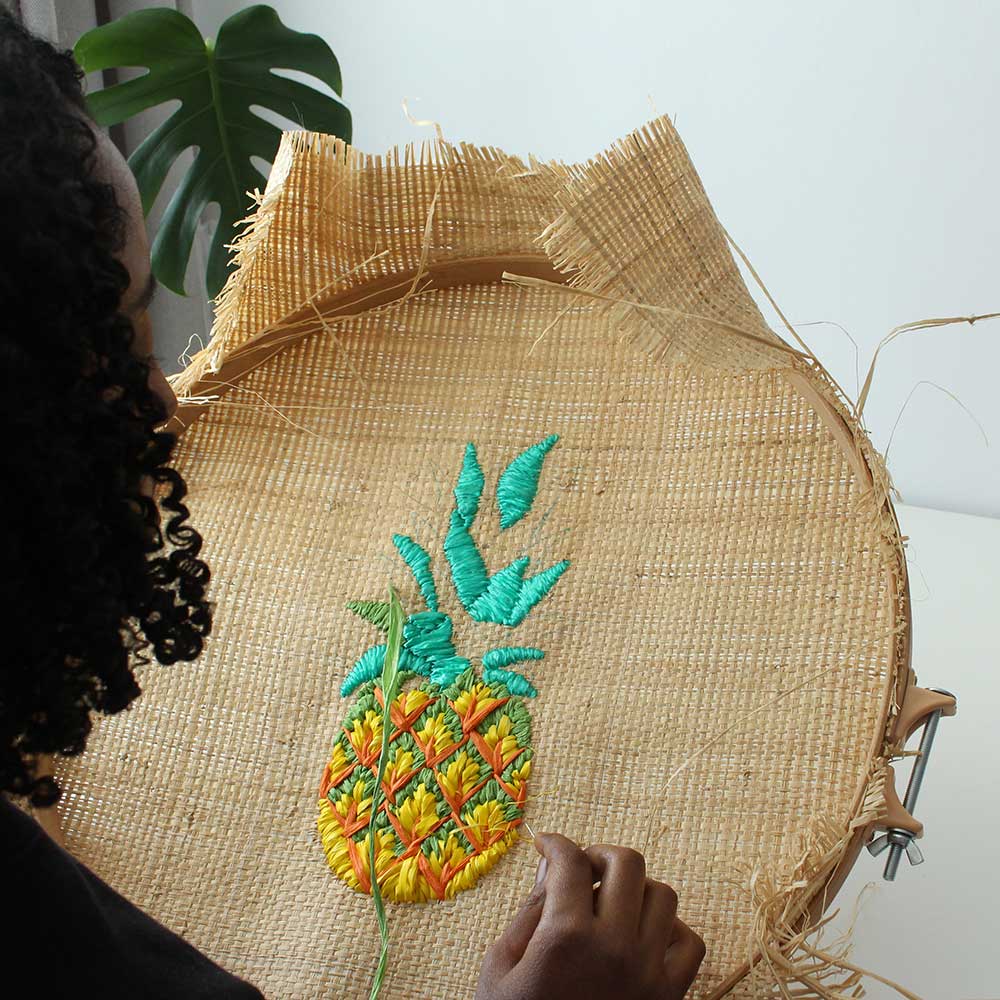 Tihara Smith doing pineapple embroidery on raffia 