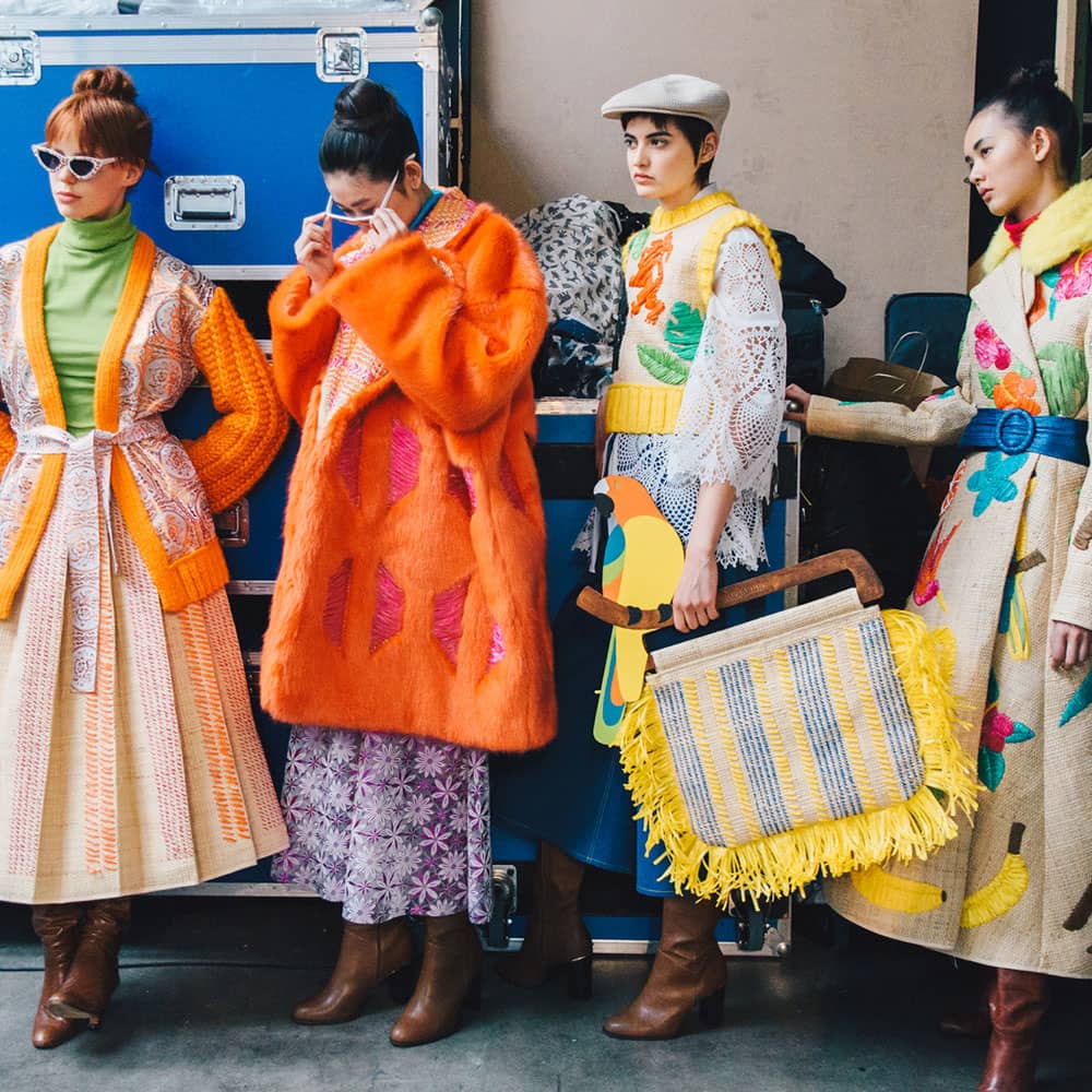 Behind the scene at Graduate Fashion Week with four models wearing Tihara Smith Windrush Collection garments
